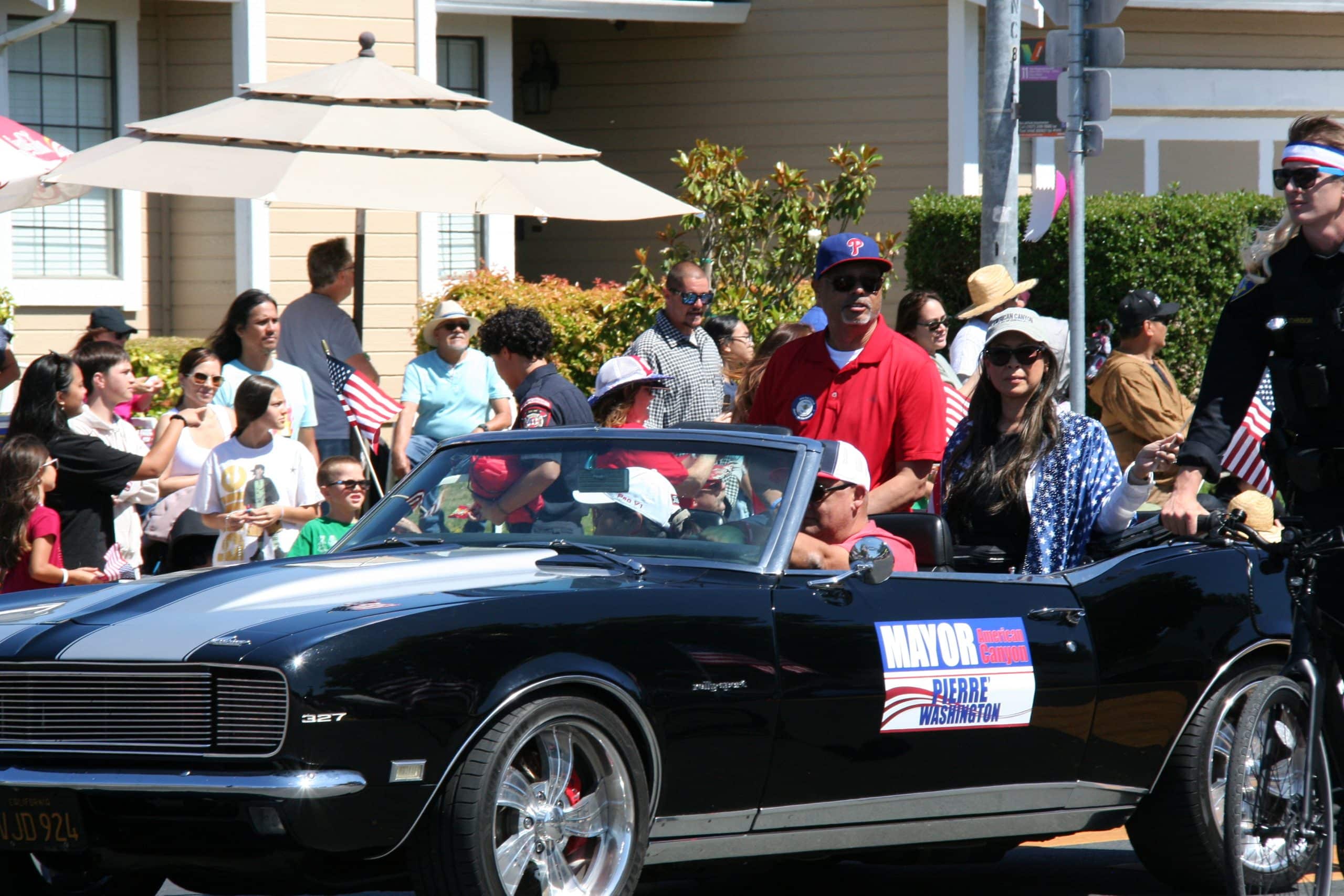 Mayor Pierre Washington riding in a 1960s sports car down the parade path. Xavey Bzdek photo